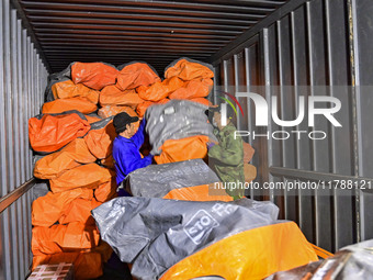 Workers sort parcels at an express logistics company in Qingzhou, China, on November 11, 2024. Monitoring data from the State Post Bureau sh...