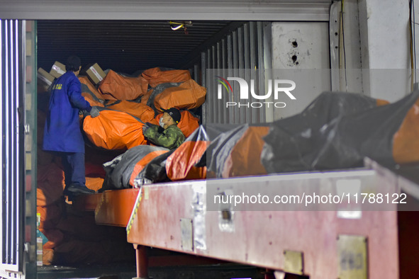 Workers sort parcels at an express logistics company in Qingzhou, China, on November 11, 2024. Monitoring data from the State Post Bureau sh...