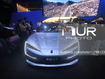 Visitors look at the newly released YANGWANG U7 luxury sedan at the Guangzhou Auto Show in Guangzhou, China, on November 15, 2024. (