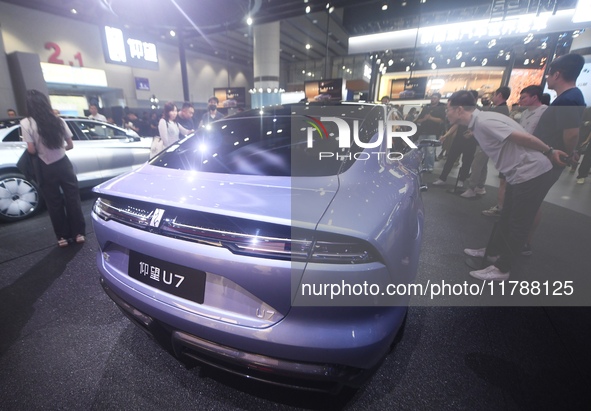 Visitors look at the newly released YANGWANG U7 luxury sedan at the Guangzhou Auto Show in Guangzhou, China, on November 15, 2024. 