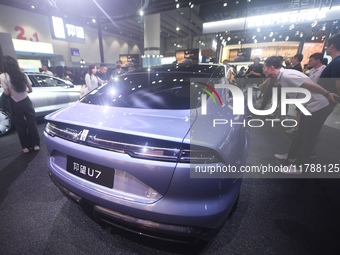 Visitors look at the newly released YANGWANG U7 luxury sedan at the Guangzhou Auto Show in Guangzhou, China, on November 15, 2024. (