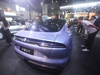 Visitors look at the newly released YANGWANG U7 luxury sedan at the Guangzhou Auto Show in Guangzhou, China, on November 15, 2024. (