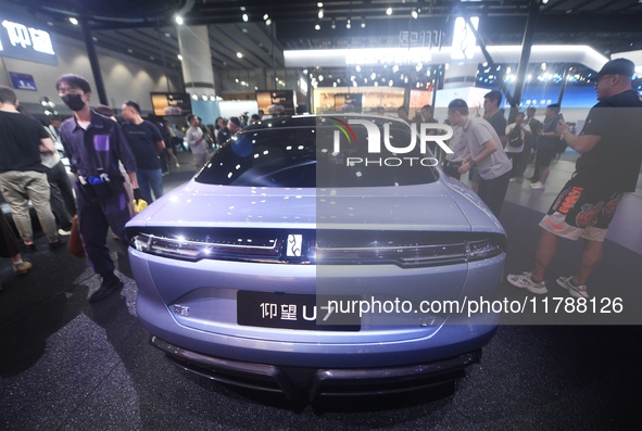 Visitors look at the newly released YANGWANG U7 luxury sedan at the Guangzhou Auto Show in Guangzhou, China, on November 15, 2024. 