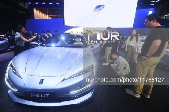 Visitors look at the newly released YANGWANG U7 luxury sedan at the Guangzhou Auto Show in Guangzhou, China, on November 15, 2024. 