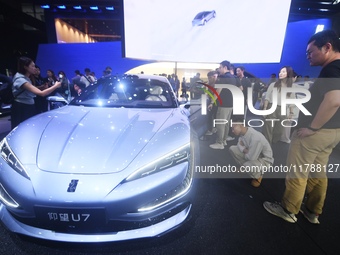 Visitors look at the newly released YANGWANG U7 luxury sedan at the Guangzhou Auto Show in Guangzhou, China, on November 15, 2024. (