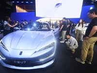 Visitors look at the newly released YANGWANG U7 luxury sedan at the Guangzhou Auto Show in Guangzhou, China, on November 15, 2024. (