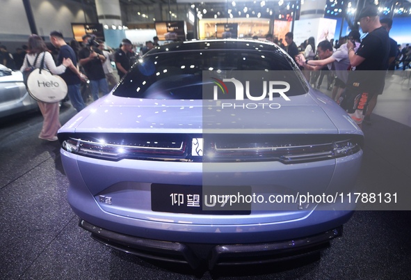 Visitors look at the newly released YANGWANG U7 luxury sedan at the Guangzhou Auto Show in Guangzhou, China, on November 15, 2024. 