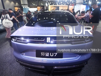 Visitors look at the newly released YANGWANG U7 luxury sedan at the Guangzhou Auto Show in Guangzhou, China, on November 15, 2024. (