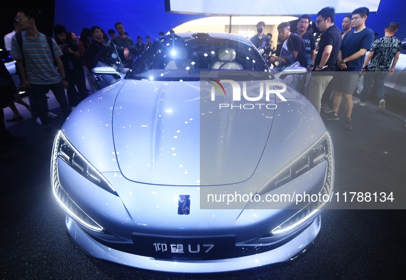 Visitors look at the newly released YANGWANG U7 luxury sedan at the Guangzhou Auto Show in Guangzhou, China, on November 15, 2024. 