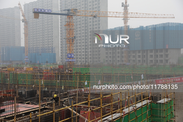 Workers work at a housing project site in Xi'an, Shaanxi province, China, on November 12, 2024. 