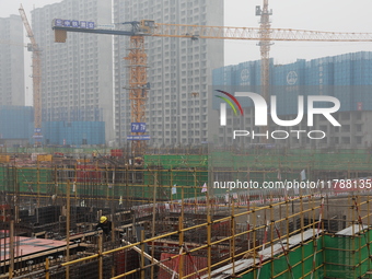 Workers work at a housing project site in Xi'an, Shaanxi province, China, on November 12, 2024. (