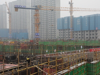 Workers work at a housing project site in Xi'an, Shaanxi province, China, on November 12, 2024. (