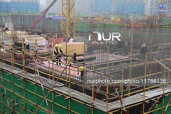 Workers work at a housing project site in Xi'an, Shaanxi province, China, on November 12, 2024. 