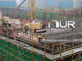 Workers work at a housing project site in Xi'an, Shaanxi province, China, on November 12, 2024. (