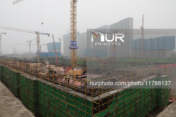 Workers work at a housing project site in Xi'an, Shaanxi province, China, on November 12, 2024. 