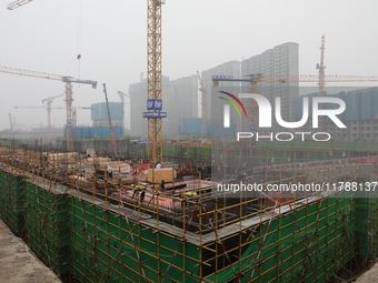 Workers work at a housing project site in Xi'an, Shaanxi province, China, on November 12, 2024. (