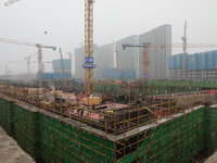 Workers work at a housing project site in Xi'an, Shaanxi province, China, on November 12, 2024. (