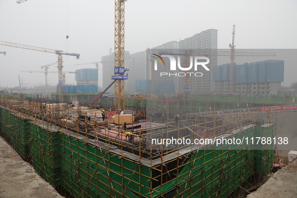 Workers work at a housing project site in Xi'an, Shaanxi province, China, on November 12, 2024. 