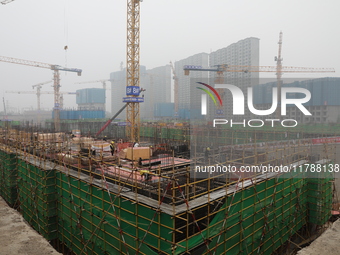 Workers work at a housing project site in Xi'an, Shaanxi province, China, on November 12, 2024. (