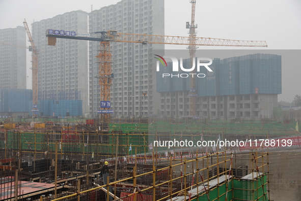 Workers work at a housing project site in Xi'an, Shaanxi province, China, on November 12, 2024. 