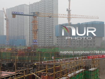 Workers work at a housing project site in Xi'an, Shaanxi province, China, on November 12, 2024. (