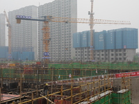 Workers work at a housing project site in Xi'an, Shaanxi province, China, on November 12, 2024. (