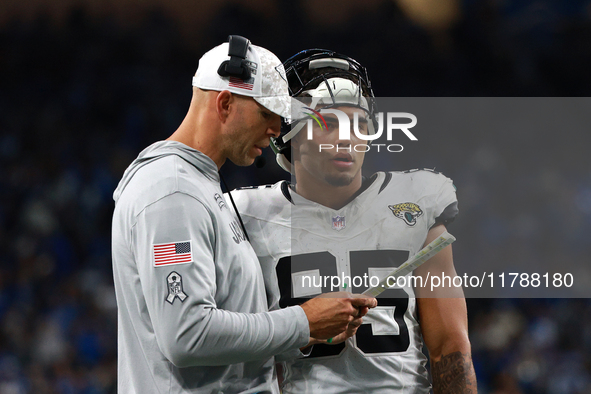 DETROIT,MICHIGAN-November 17: Jacksonville Jaguars tight ends coach Richard Angulo talks to tight end Brenton Strange (85) during the second...