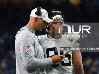 DETROIT,MICHIGAN-November 17: Jacksonville Jaguars tight ends coach Richard Angulo talks to tight end Brenton Strange (85) during the second...