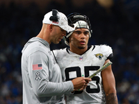 DETROIT,MICHIGAN-November 17: Jacksonville Jaguars tight ends coach Richard Angulo talks to tight end Brenton Strange (85) during the second...