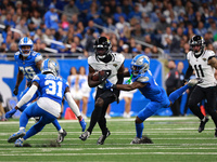 DETROIT,MICHIGAN-November 17: Jacksonville Jaguars wide receiver Brian Thomas Jr. (7) runs the ball during the second half of an NFL footbal...