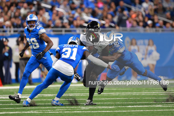 DETROIT,MICHIGAN-November 17: Jacksonville Jaguars wide receiver Brian Thomas Jr. (7) is tackled by Detroit Lions cornerback Terrion Arnold...