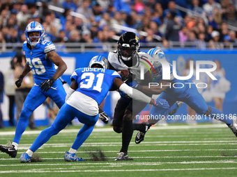 DETROIT,MICHIGAN-November 17: Jacksonville Jaguars wide receiver Brian Thomas Jr. (7) is tackled by Detroit Lions cornerback Terrion Arnold...