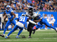 DETROIT,MICHIGAN-November 17: Jacksonville Jaguars wide receiver Brian Thomas Jr. (7) is tackled by Detroit Lions cornerback Terrion Arnold...