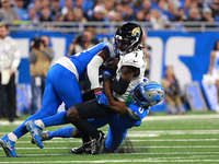 DETROIT,MICHIGAN-November 17: Jacksonville Jaguars wide receiver Brian Thomas Jr. (7) is tackled by Detroit Lions cornerback Terrion Arnold...