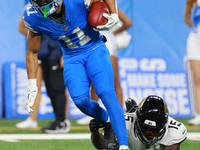 DETROIT,MICHIGAN-November 17: Detroit Lions wide receiver Kalif Raymond (11) runs the ball against Jacksonville Jaguars wide receiver Tim Jo...