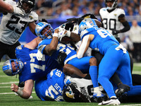 DETROIT,MICHIGAN-November 17: Detroit Lions running back Jahmyr Gibbs (26) is tackled during the second half of an NFL football game between...