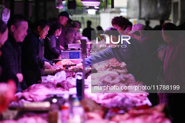 Citizens buy pork at a farmer's market in Nanjing, China, on November 18, 2024. 