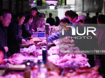 Citizens buy pork at a farmer's market in Nanjing, China, on November 18, 2024. (