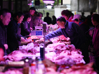 Citizens buy pork at a farmer's market in Nanjing, China, on November 18, 2024. (