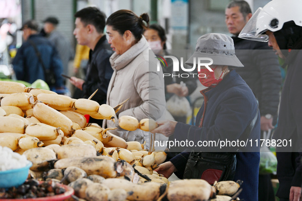 Citizens buy vegetables at a farmer's market in Nanjing, China, on November 18, 2024. 