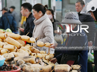 Citizens buy vegetables at a farmer's market in Nanjing, China, on November 18, 2024. (