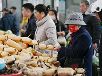 Citizens buy vegetables at a farmer's market in Nanjing, China, on November 18, 2024. (