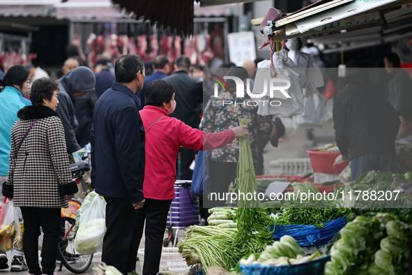 Citizens buy vegetables at a farmer's market in Nanjing, China, on November 18, 2024. 