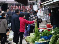 Citizens buy vegetables at a farmer's market in Nanjing, China, on November 18, 2024. (