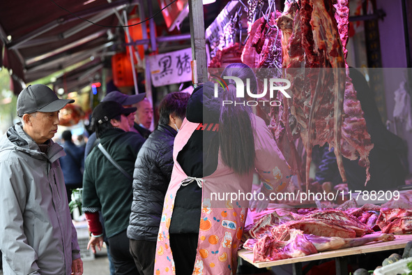 Citizens buy pork at a farmer's market in Nanjing, China, on November 18, 2024. 