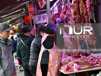 Citizens buy pork at a farmer's market in Nanjing, China, on November 18, 2024. (