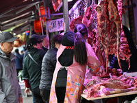 Citizens buy pork at a farmer's market in Nanjing, China, on November 18, 2024. (