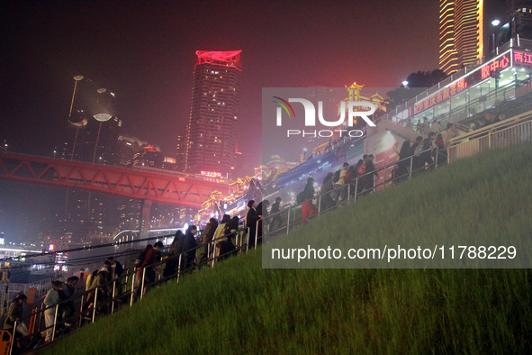 Tourists visit the Hong Ya Dong scenic area in Chongqing, China, on November 7, 2024. 