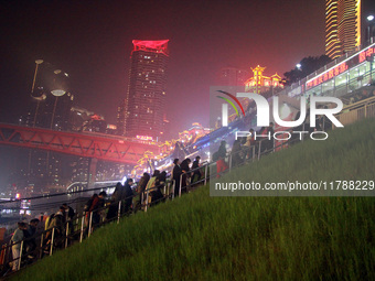 Tourists visit the Hong Ya Dong scenic area in Chongqing, China, on November 7, 2024. (