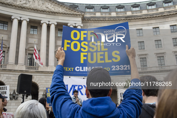 Environmental activists rally to demand climate action before US President-elect Donald Trump takes office in Washington, DC, on November 17...